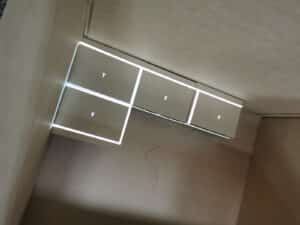 View inside a shipping crate with a light projection outlining the next object to be placed inside it.