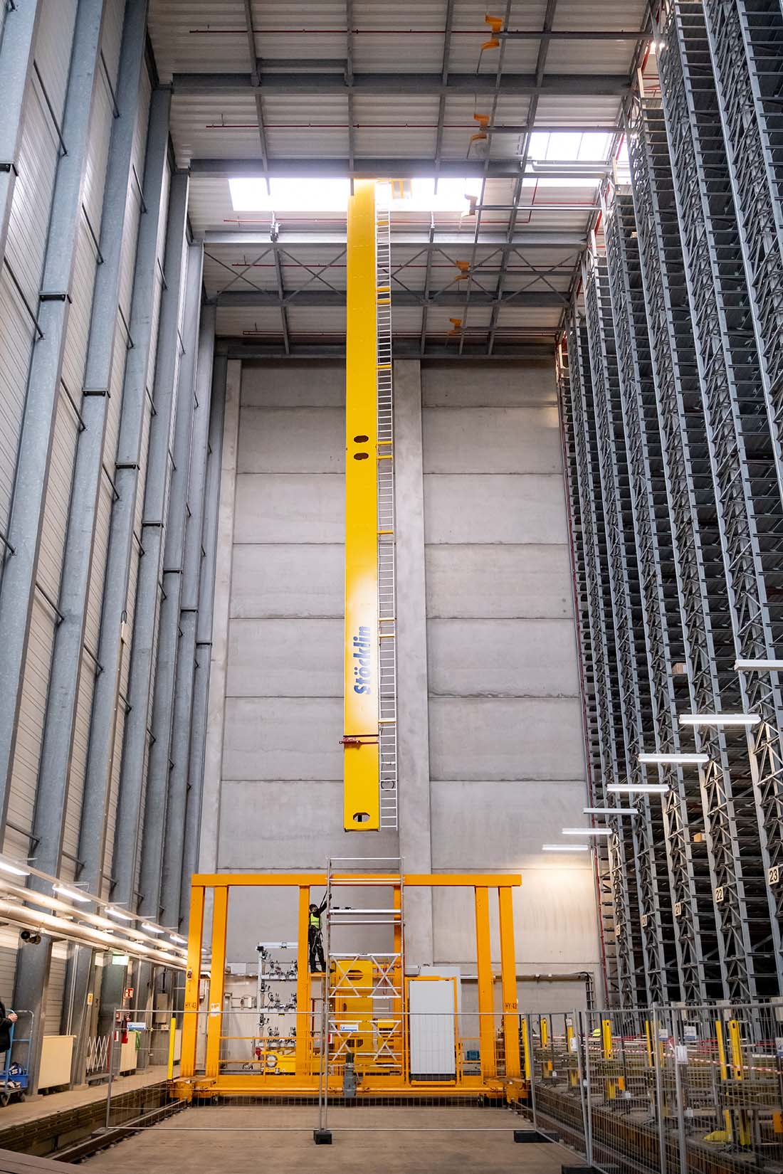 A St&ouml;ckling-brand stacker crane is being lowered through the roof hatch with the help of cranes. Photo: Andreas Lander