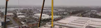 Ein gelbes Regalbediengerät der Stöckling Group wird über eine Dachluke in den Standort Haldensleben der Hermes Fulfillment GmbH eingebracht.
